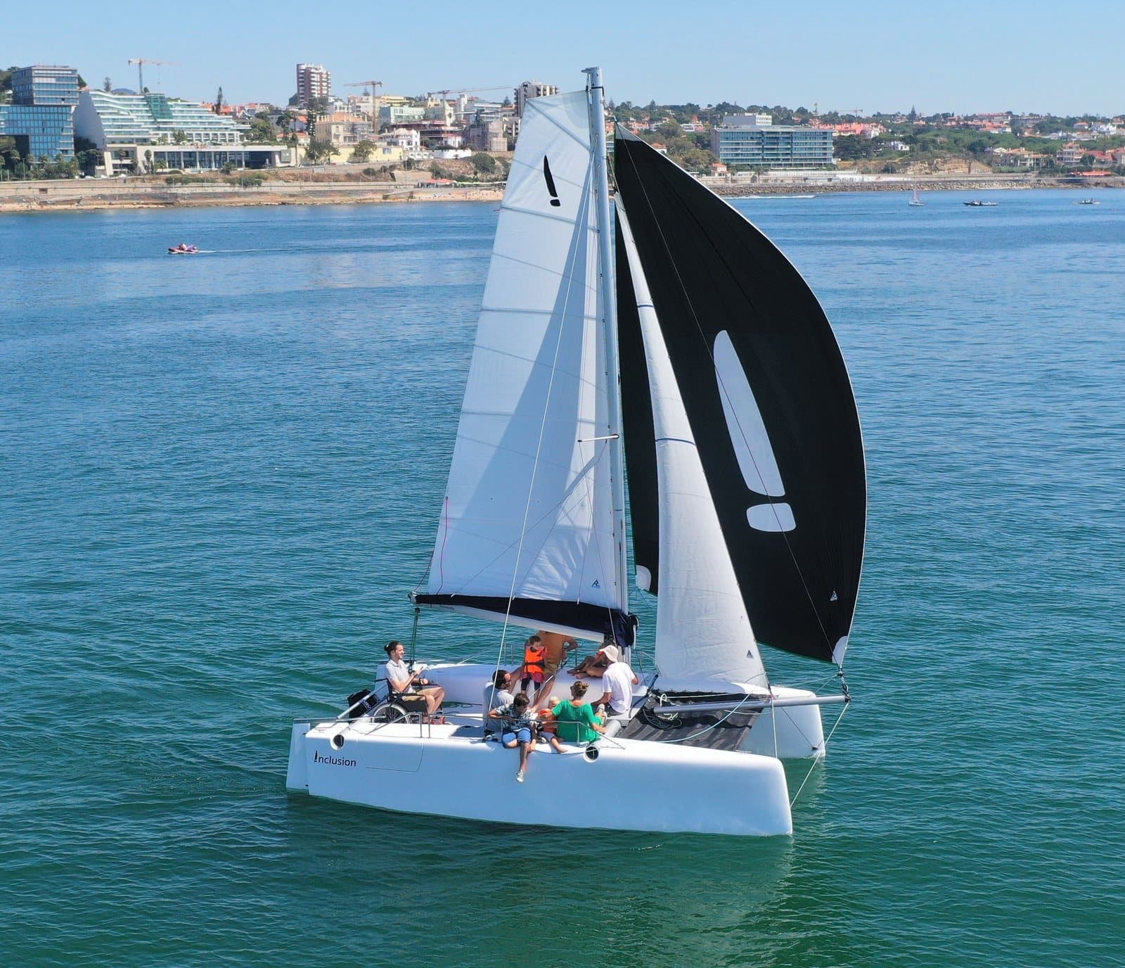A catamaran with people aboard sailing on open water