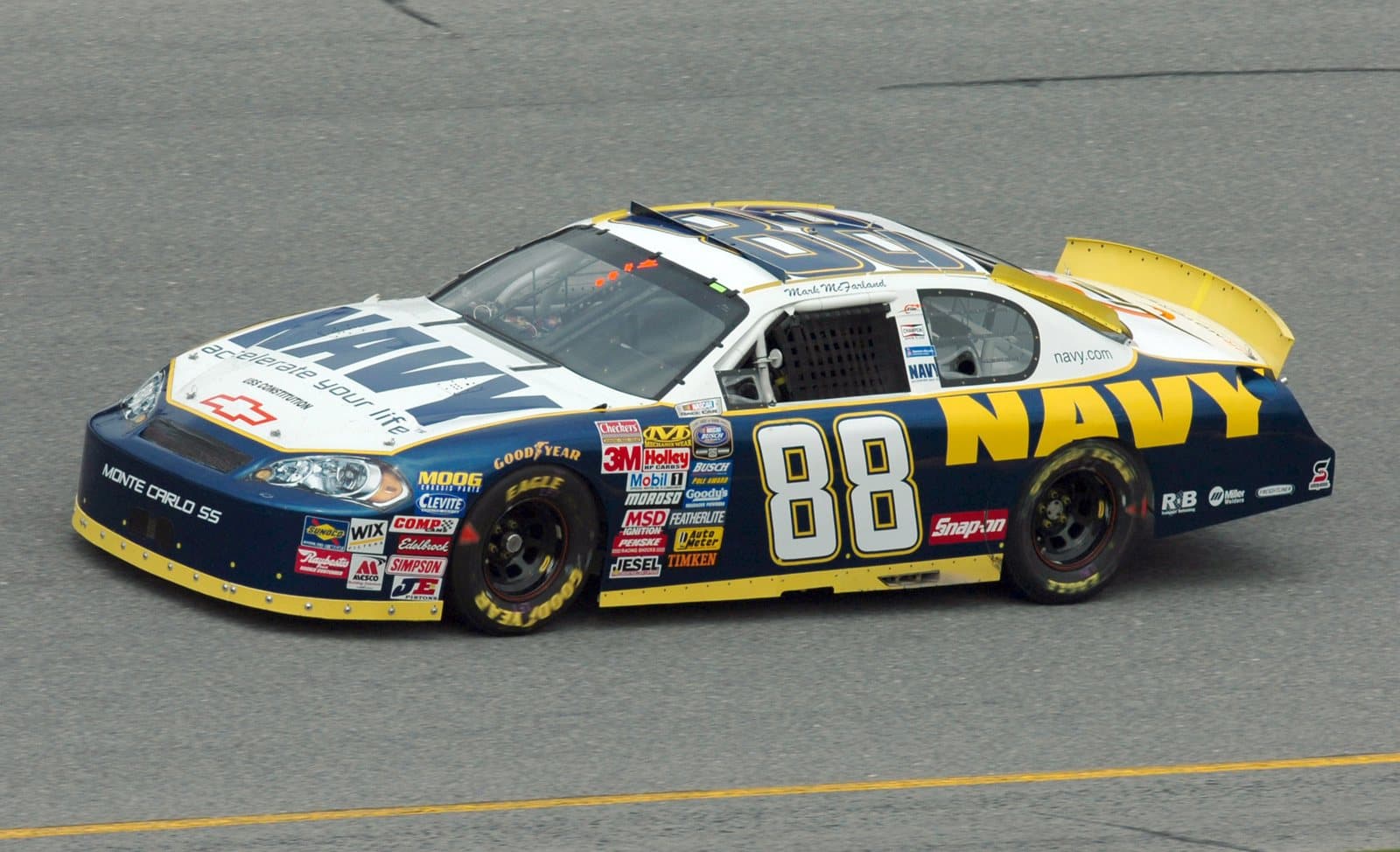 A stock car racing along an oval track